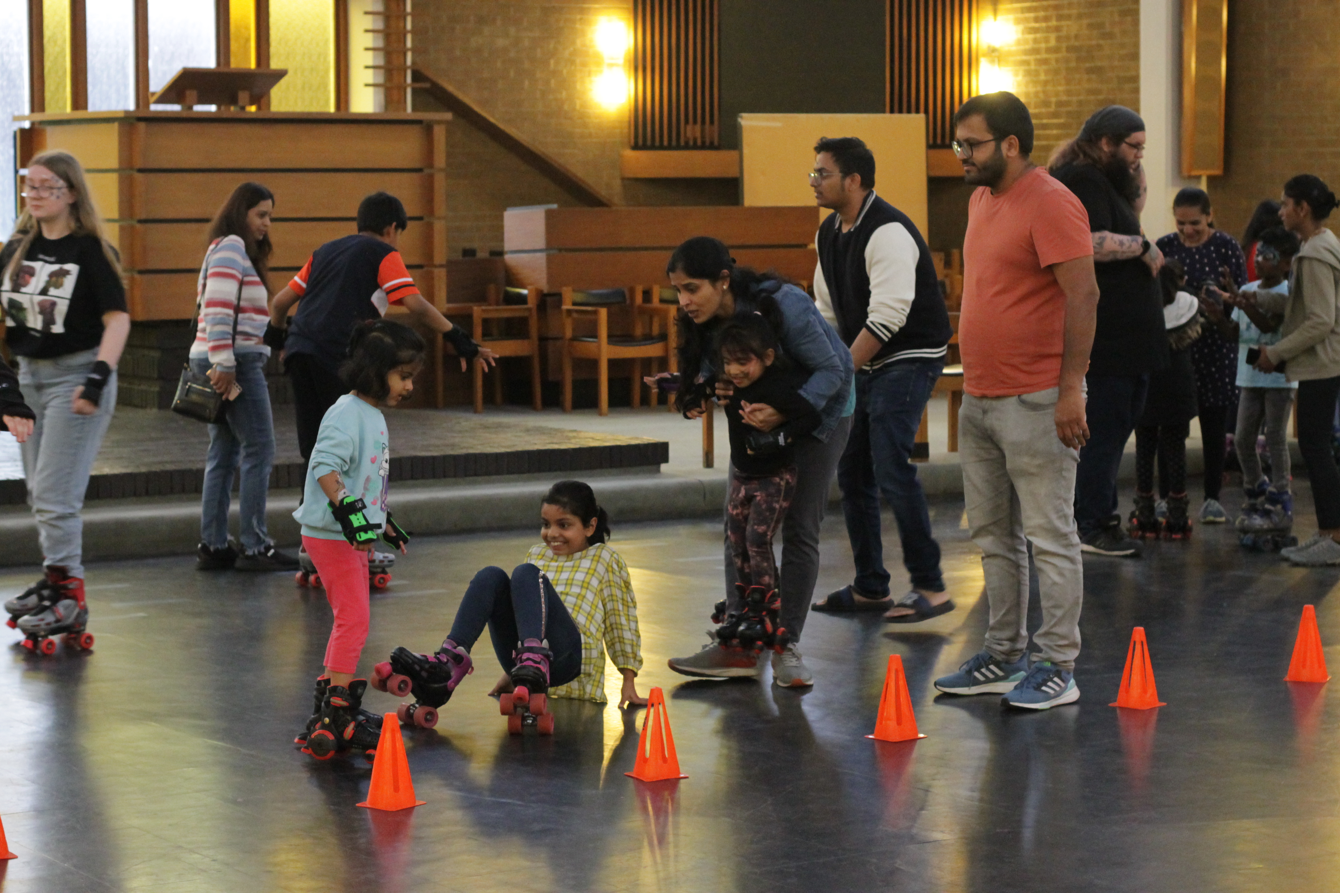 Pyramid Hall roller skating event with families and children, promoting fun and community.