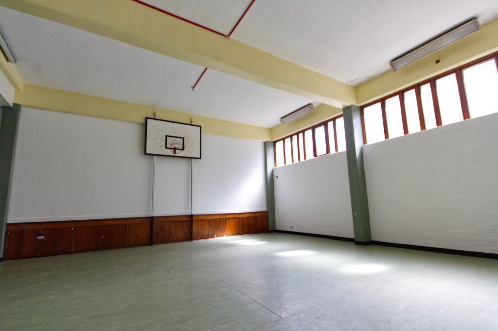 Spacious event venue with high ceilings and natural light, ideal for sports and team-building events.