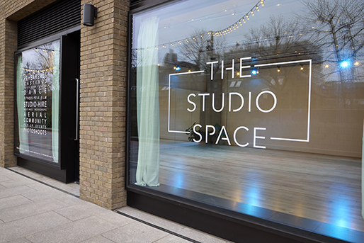 Modern event venue with large windows, ideal for corporate meetings and workshops.