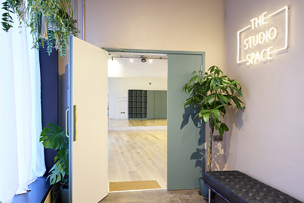 Well-lit Studio 2 entrance with modern decor, perfect for meetings and events.