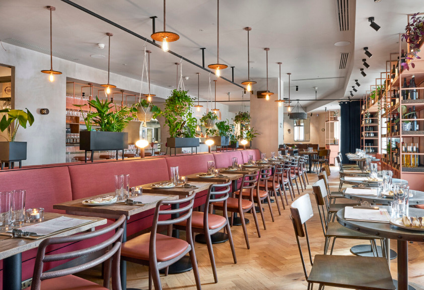 Private dining room with banquette seating at Humble Grape Canary Wharf for networking dinners.