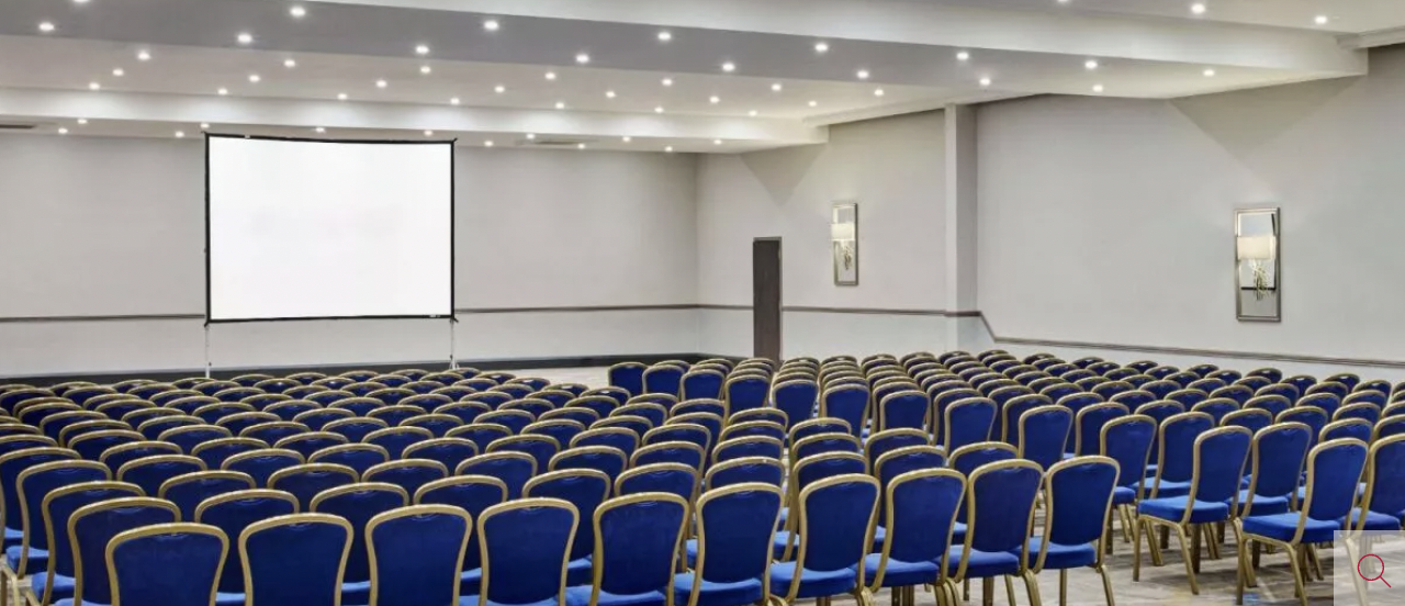Conference room in Paris Suite, Leonardo Hotel: blue chairs for seminars and workshops.