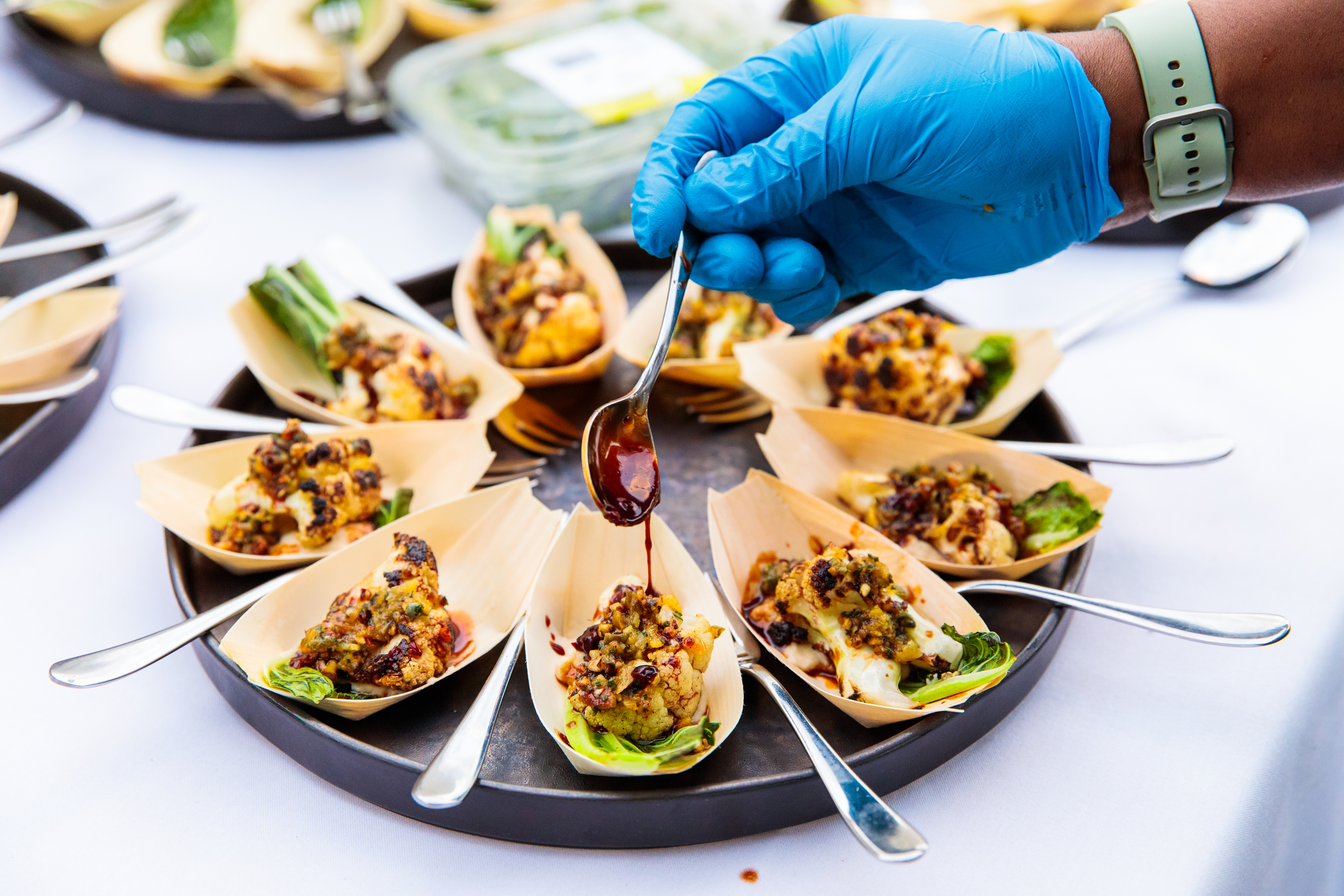 Gourmet hors d'oeuvres platter at Summer Party Rooftop event, eco-friendly presentation.