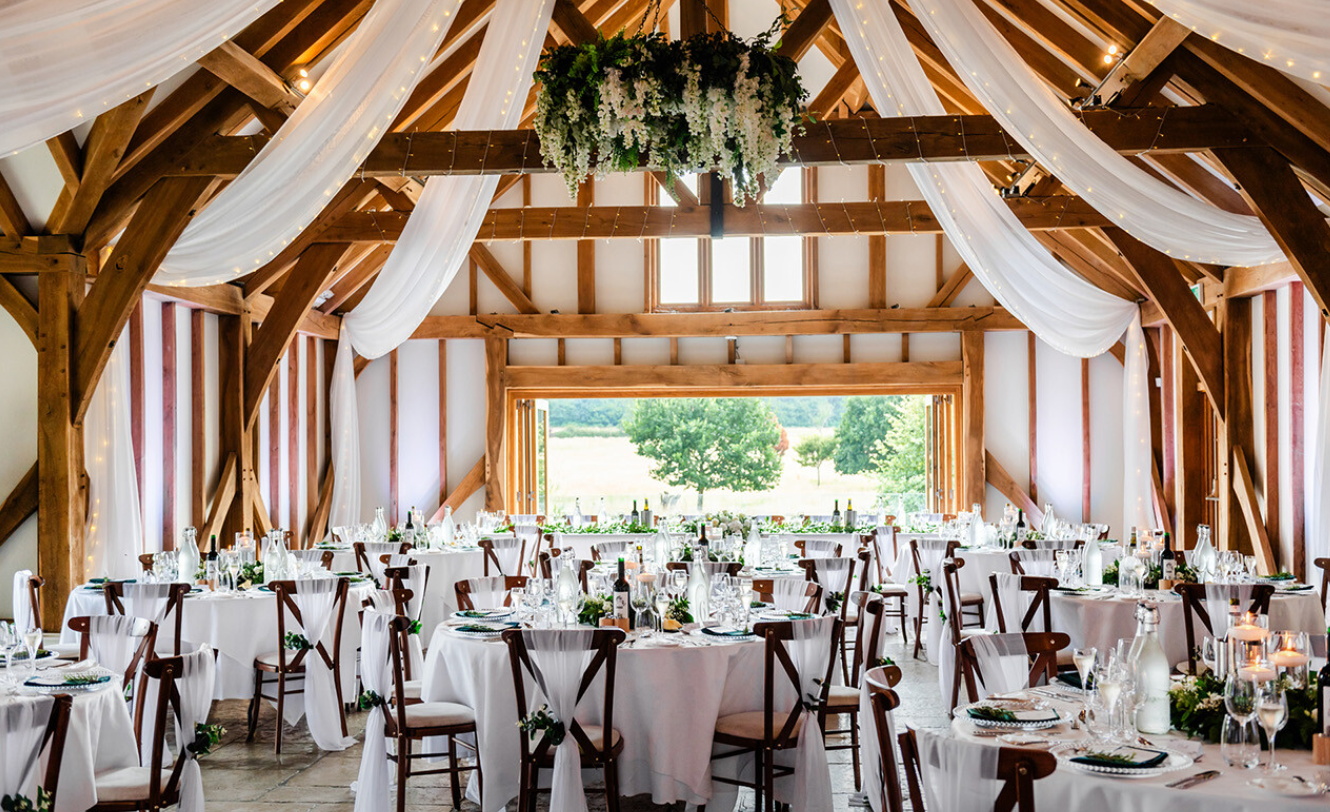 Rustic elegant event space in Brookfield Barn, ideal for summer weddings and corporate retreats.