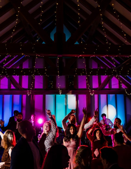 Brookfield Barn Christmas party with colorful lights and live band entertainment.