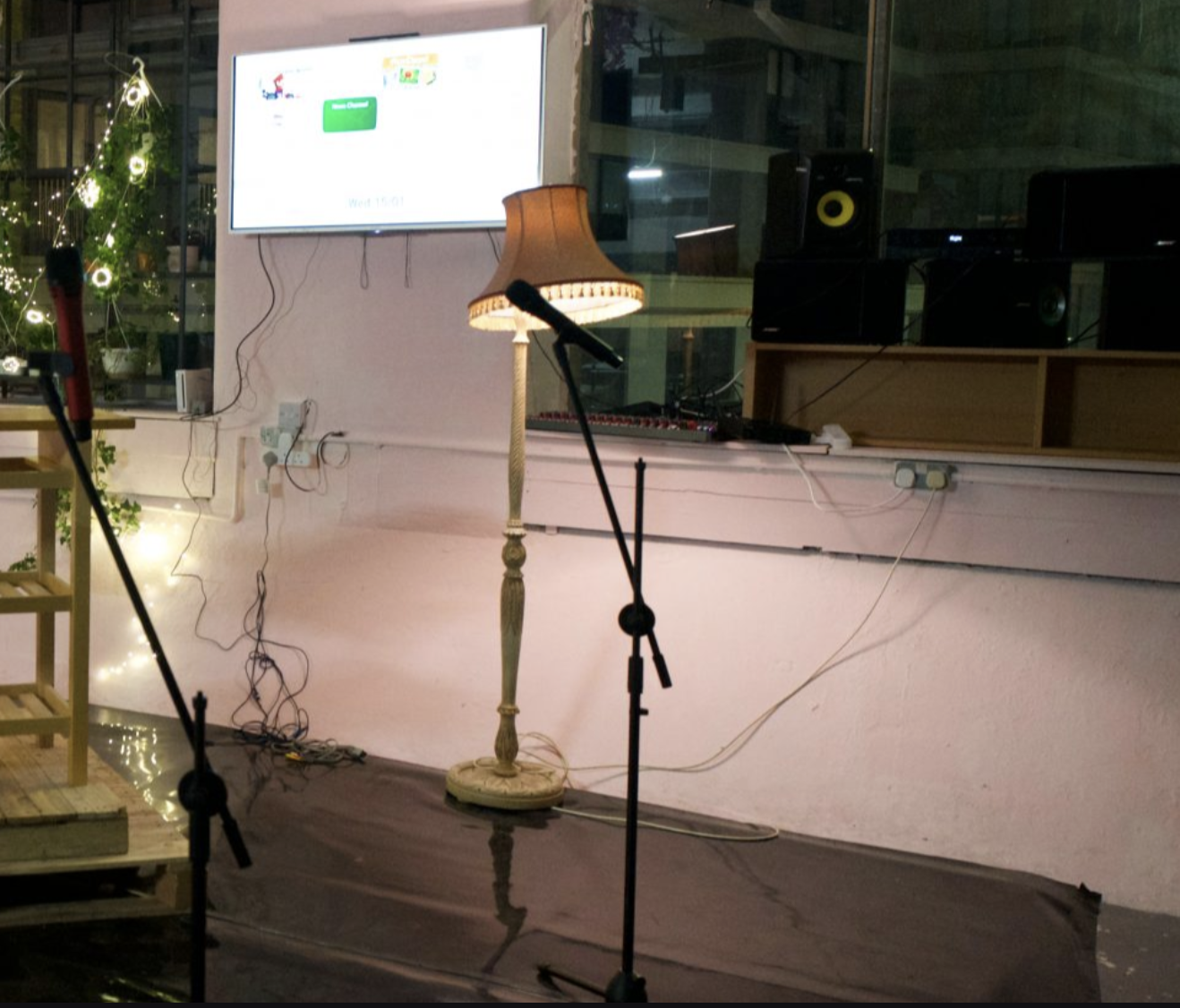 Cluttered AV setup at Shaes London venue, highlighting disorganized equipment and cable management.