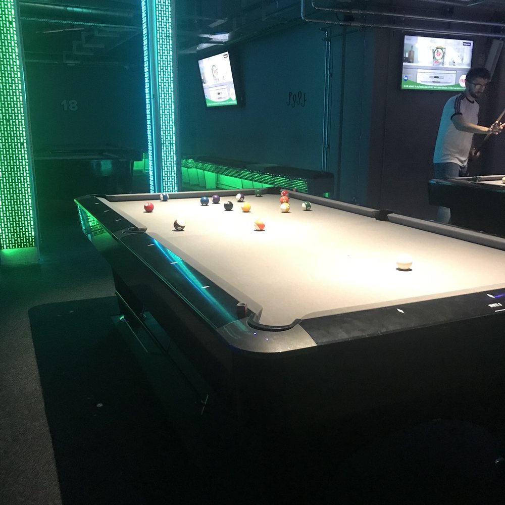Vibrant pool table in Bar 50, ideal for social networking and team-building events.