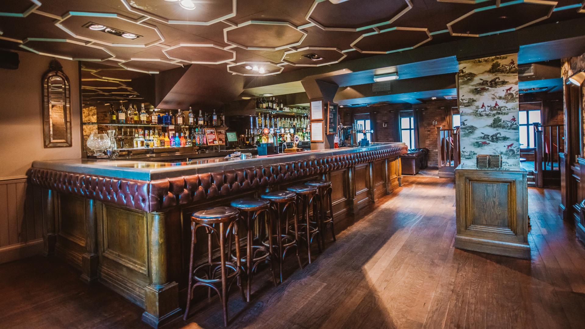 Stylish bar venue with rich wood finishes for networking events and cocktail receptions.