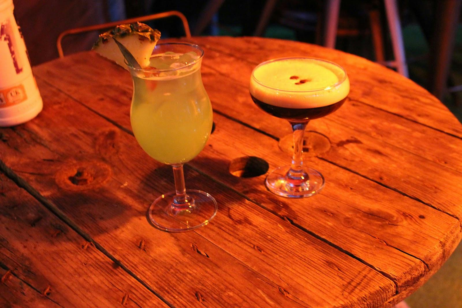 "Colorful cocktails on rustic table in Bar 50, ideal for social events and networking."