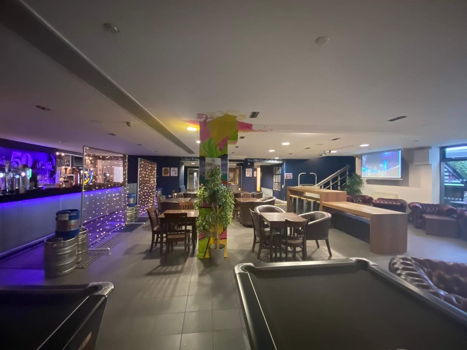 Function room at Bar 50 with modern decor, ideal for formal meetings and gatherings.