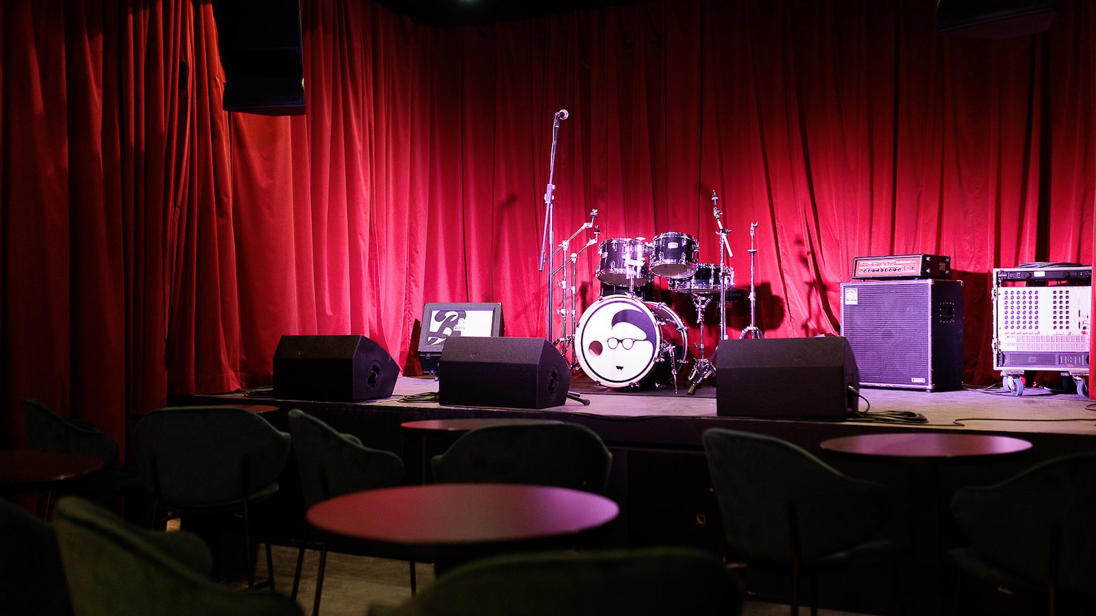 Band on the Wall stage setup with red curtains for intimate live music and concert events.