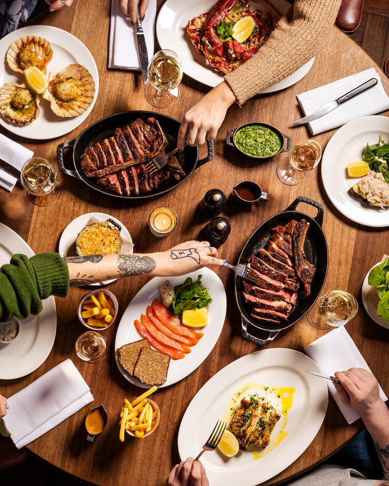 Dining table at Hawksmoor Manchester with steak, perfect for events and team-building.