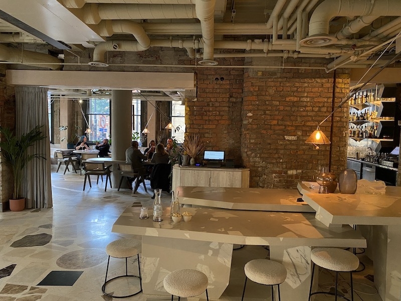Modern restaurant venue with exposed brick, ideal for meetings and events.