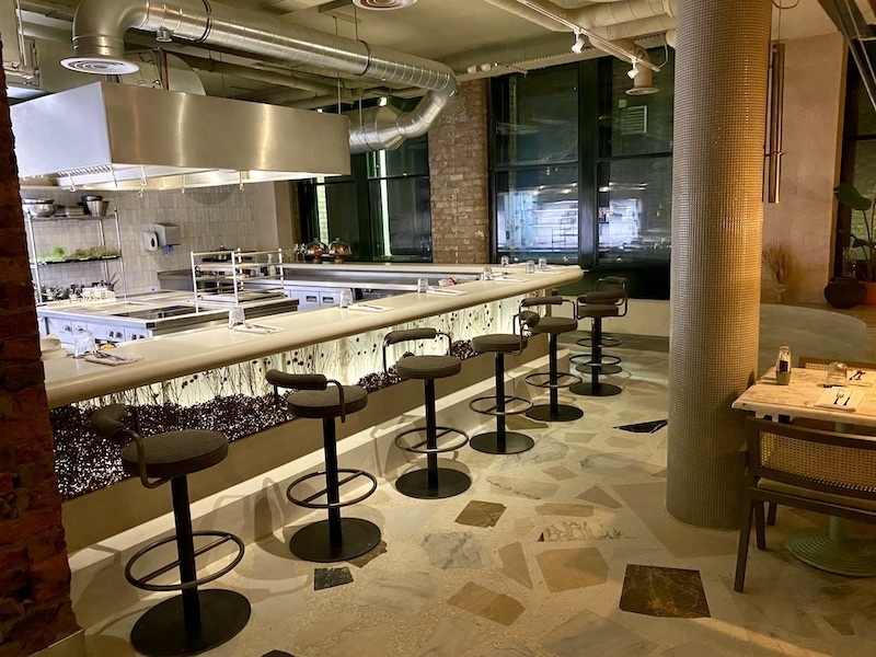 Modern kitchen venue with sleek bar seating for culinary events and cooking classes.