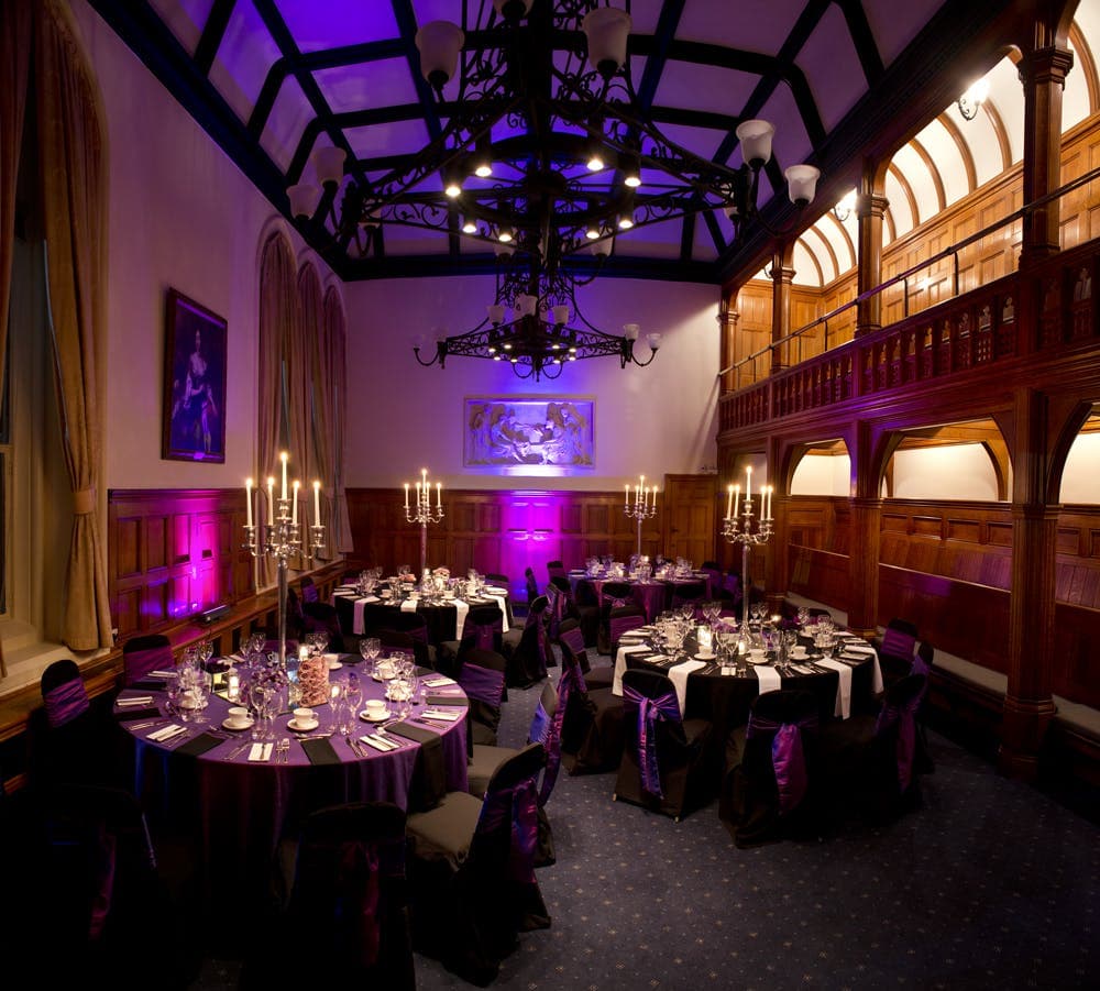 The Whitworth formal banquet: purple uplighting and candelabra centerpieces for event hire.