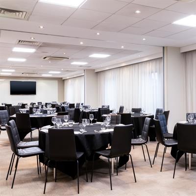Elegant dining setup in AC Hotel Manchester for corporate meetings and formal events.