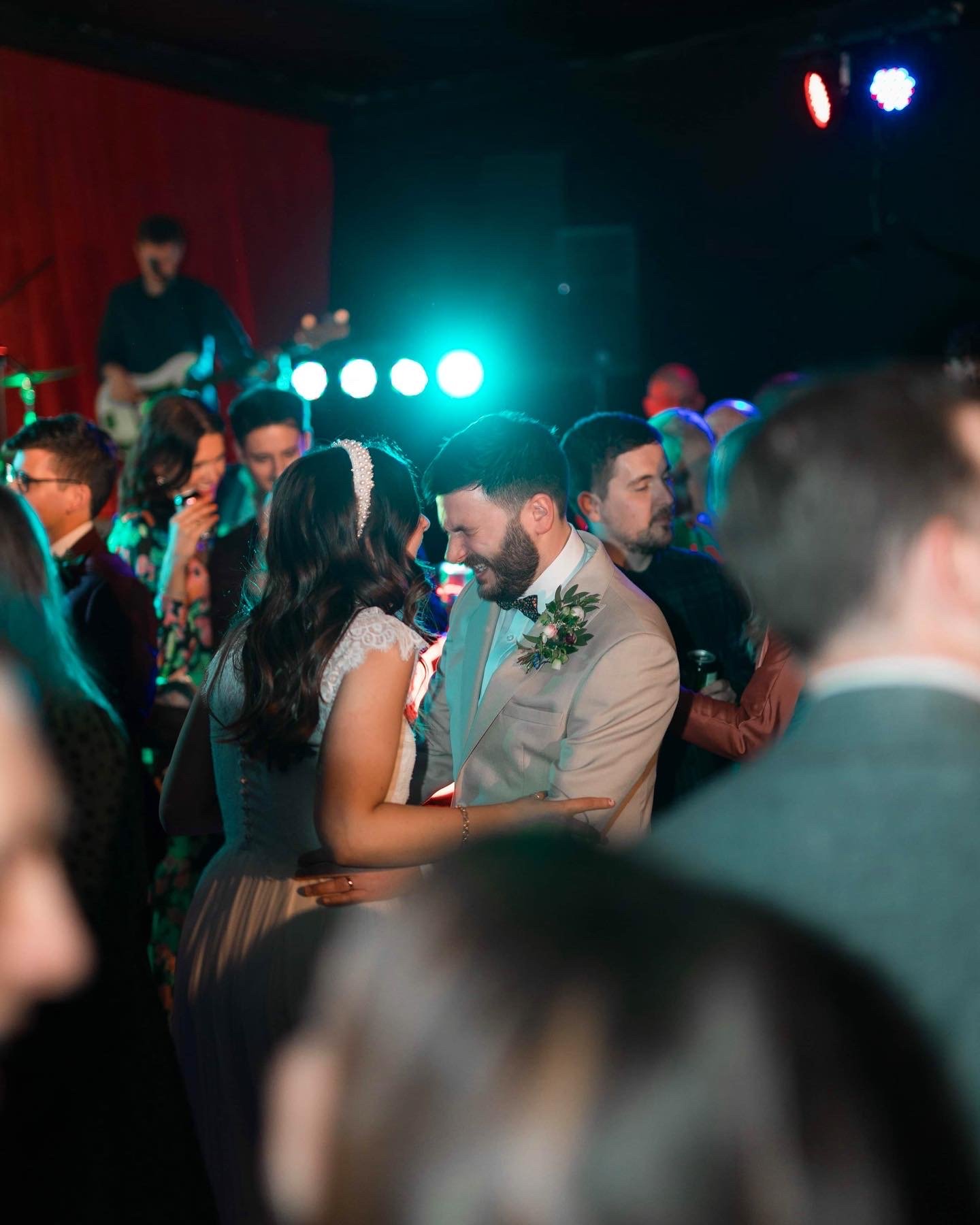 Lively wedding reception at GRUB MCR with vibrant lighting and live band entertainment.