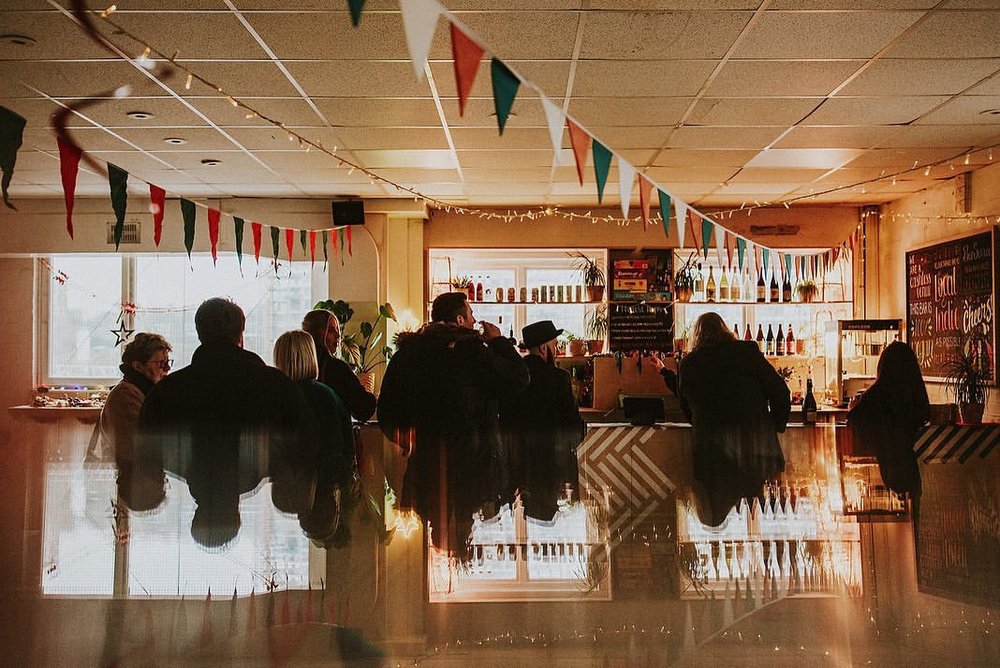 Lively GRUB MCR dining room with festive bunting, perfect for networking events and gatherings.