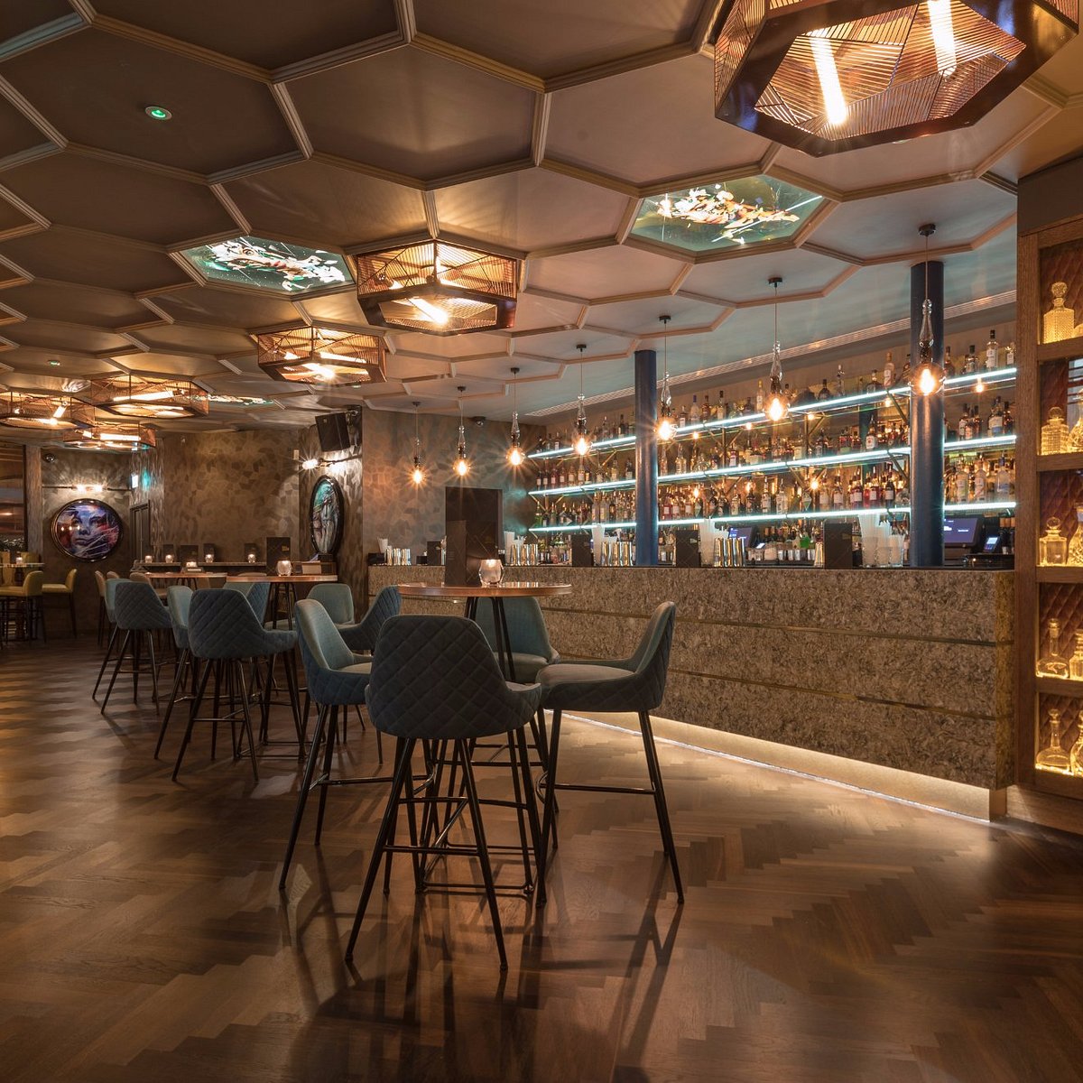 Stylish cocktail bar in Dirty Martini Manchester with illuminated spirit shelf, perfect for events.