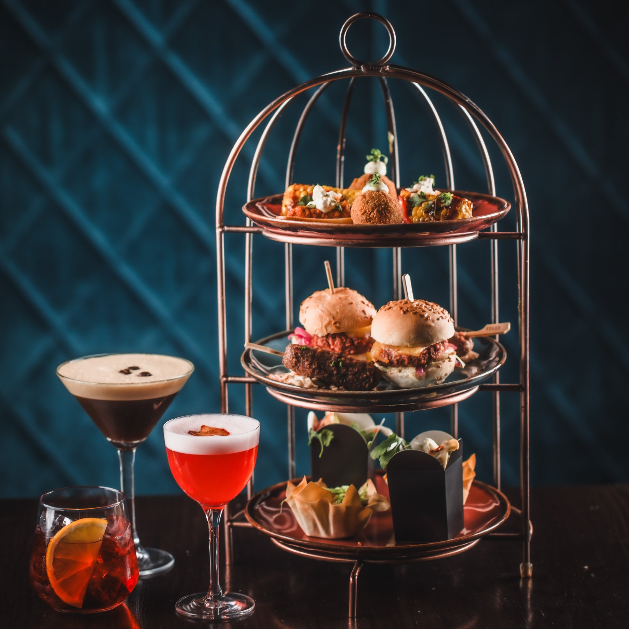 Stylish cocktail bar food presentation with gourmet sliders for upscale events.