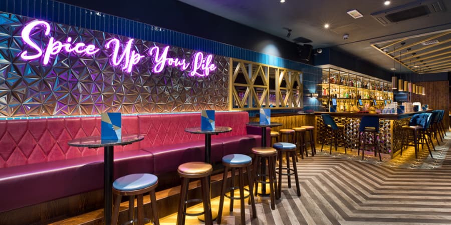 Vibrant Private Hire Venue with neon signage in All Bar One Manchester for cocktail receptions.