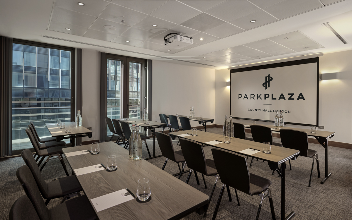 Modern meeting room with classroom-style tables for corporate events at Park Plaza County Hall.