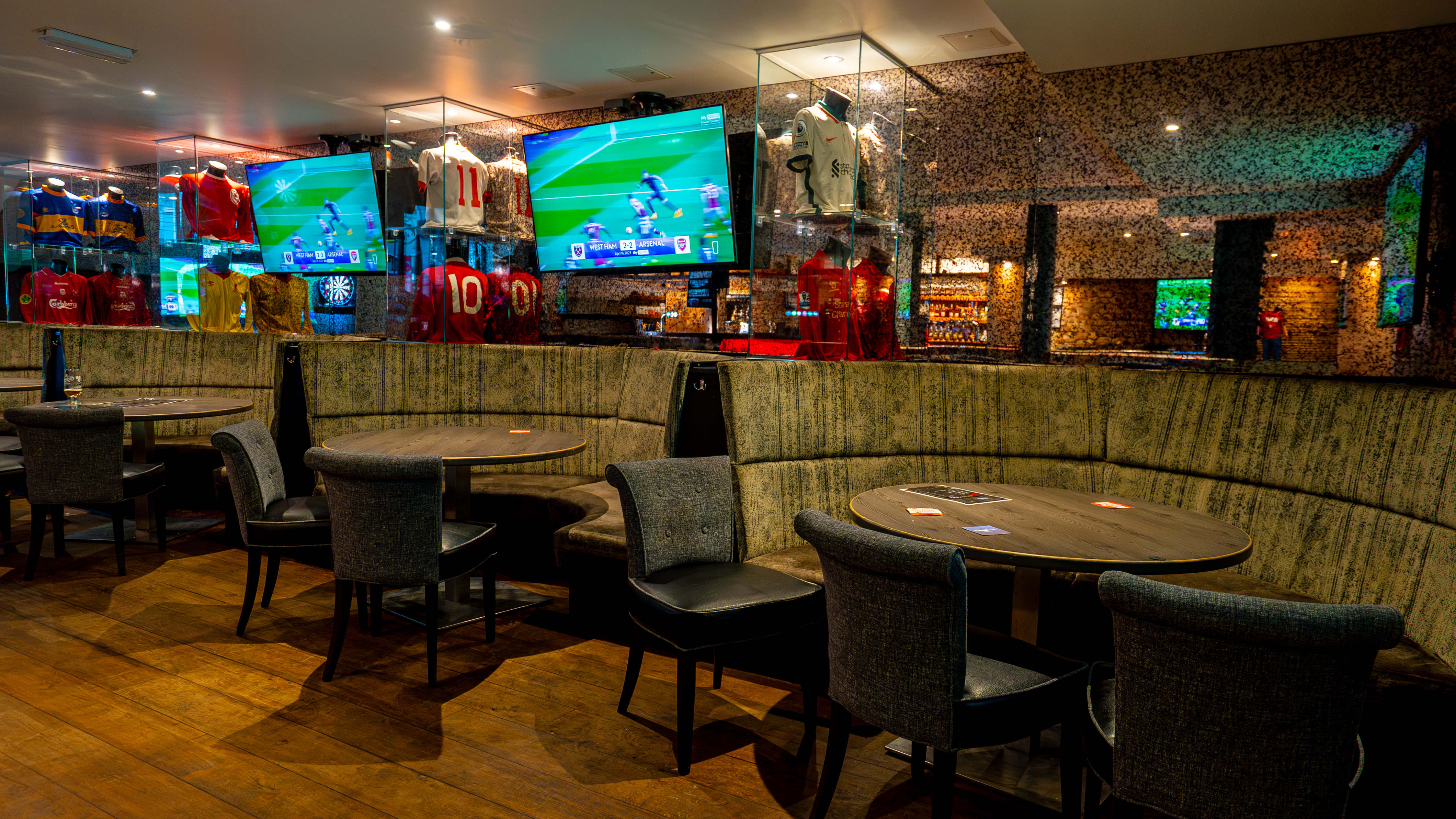 Reds Liverpool bar with booth seating, ideal for corporate networking and sports hospitality events.