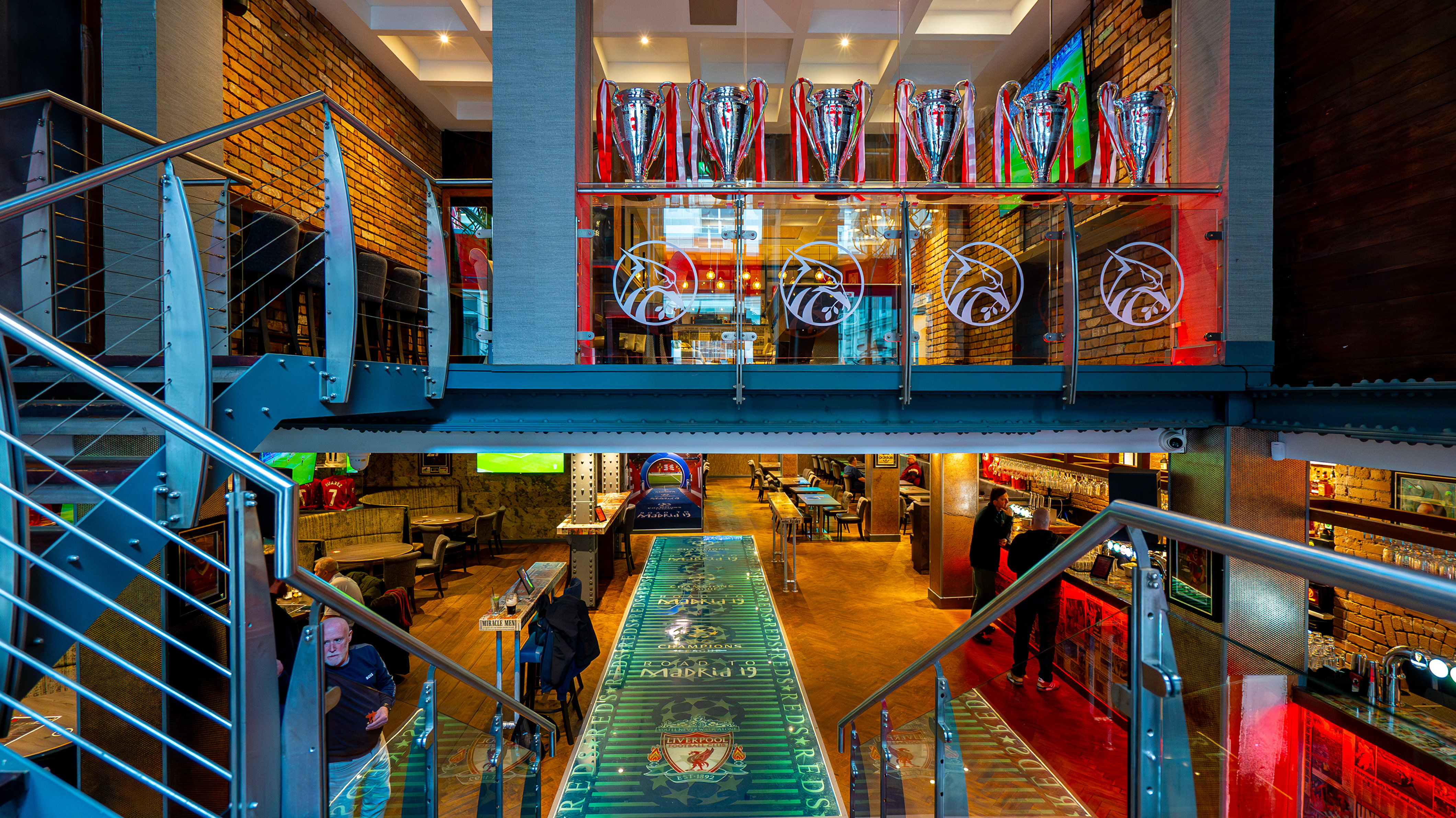 Industrial chic Reds Liverpool bar with tiered seating for sports parties and corporate events.