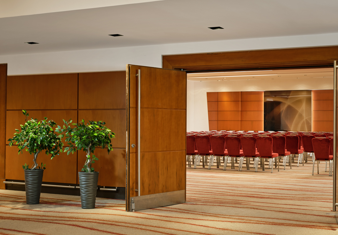 Victoria Suite at Park Plaza Victoria London, modern meeting space with red chairs.