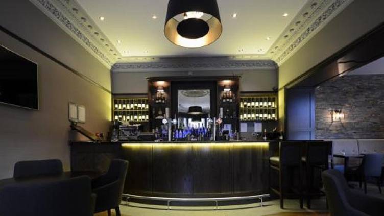 Sophisticated hotel bar with warm lighting for VIP networking and cocktail reception events.