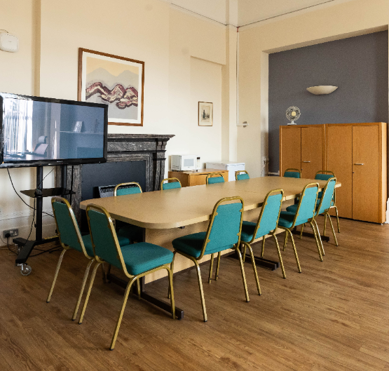 Boardroom in The Village with dated decor, ideal for corporate meetings and event space rentals.