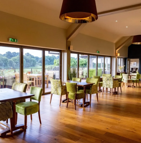 Redlibbets Golf Club event space with floor-to-ceiling windows for networking and casual dining.