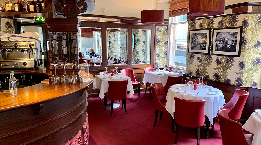 The Abbotsford Room bar with red seating, ideal for corporate dinners and VIP networking events.