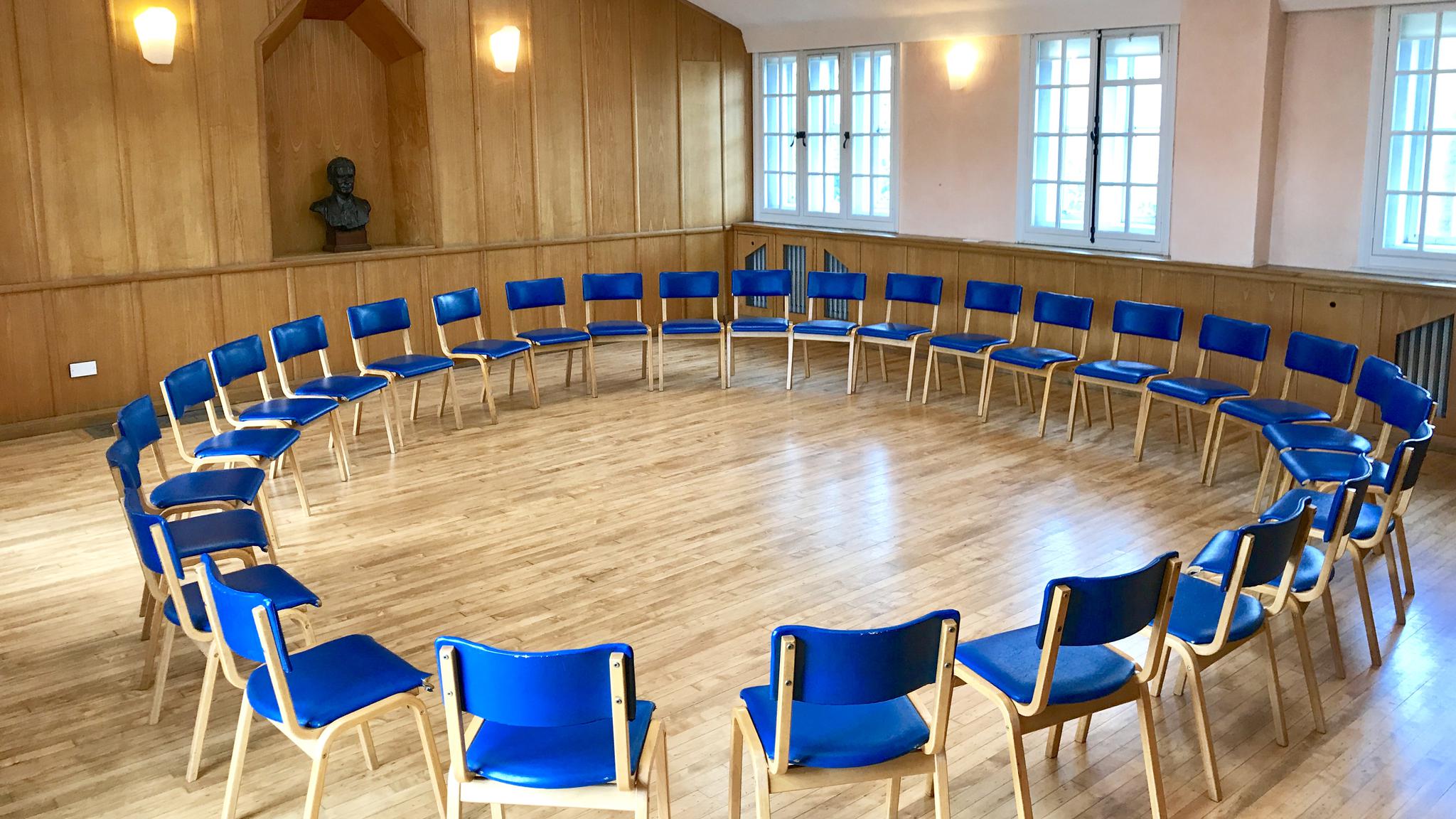 Eurythmy Room with circular blue chairs, ideal for workshops and team-building events.