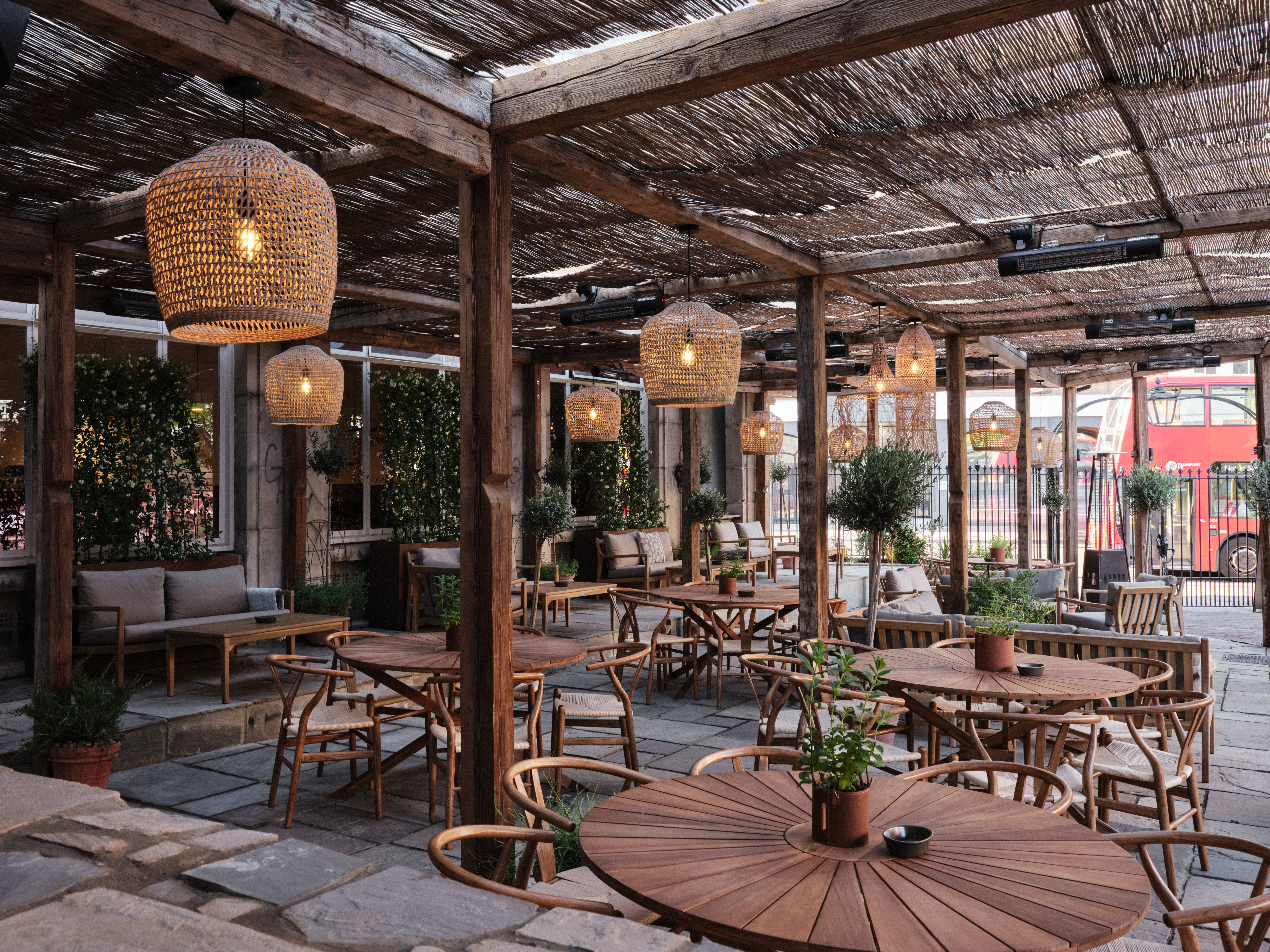 Charming outdoor venue with warm lighting, perfect for casual meetings and social events.