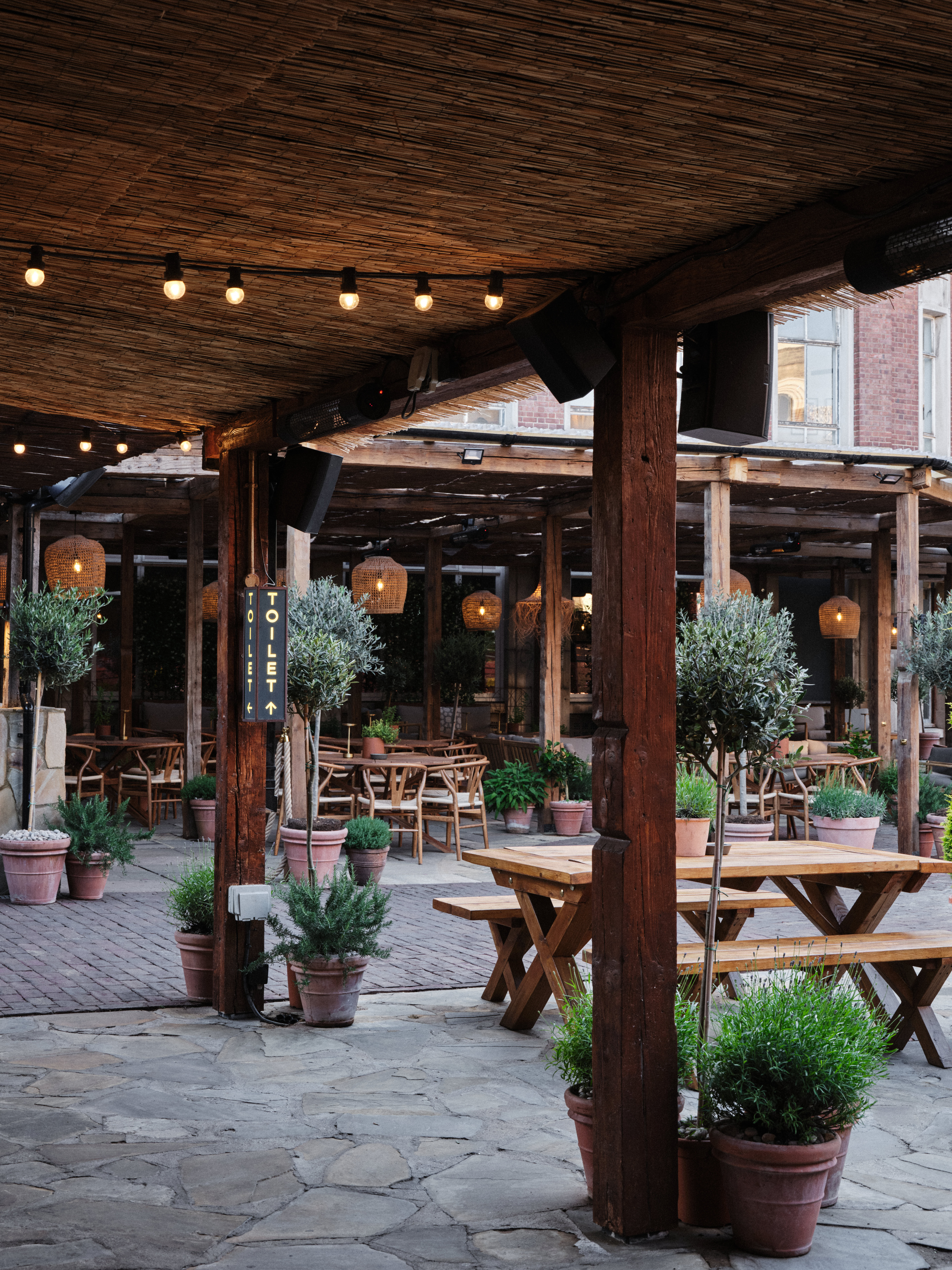 Rustic Pyro Terrace outdoor venue with seating and lanterns for events.