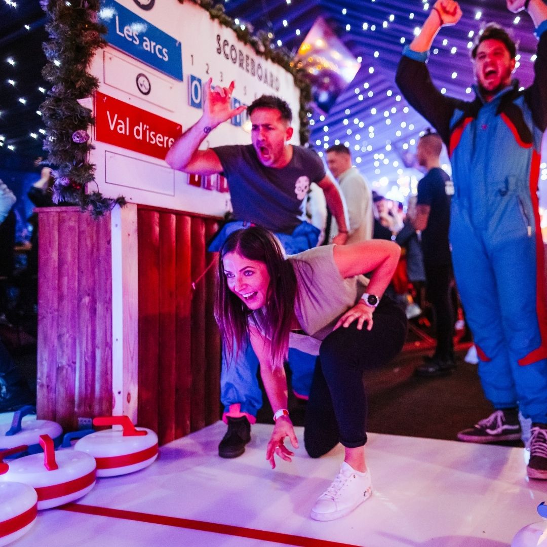 Curling Club at Vinegar Yard with branded scoreboard for corporate winter team-building events.