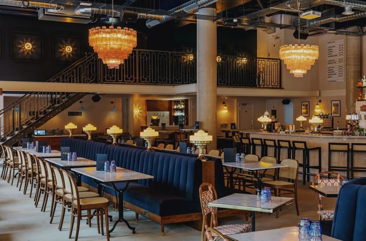 Teatro Hall industrial-chic event venue with plush seating for cocktail receptions and mixers.