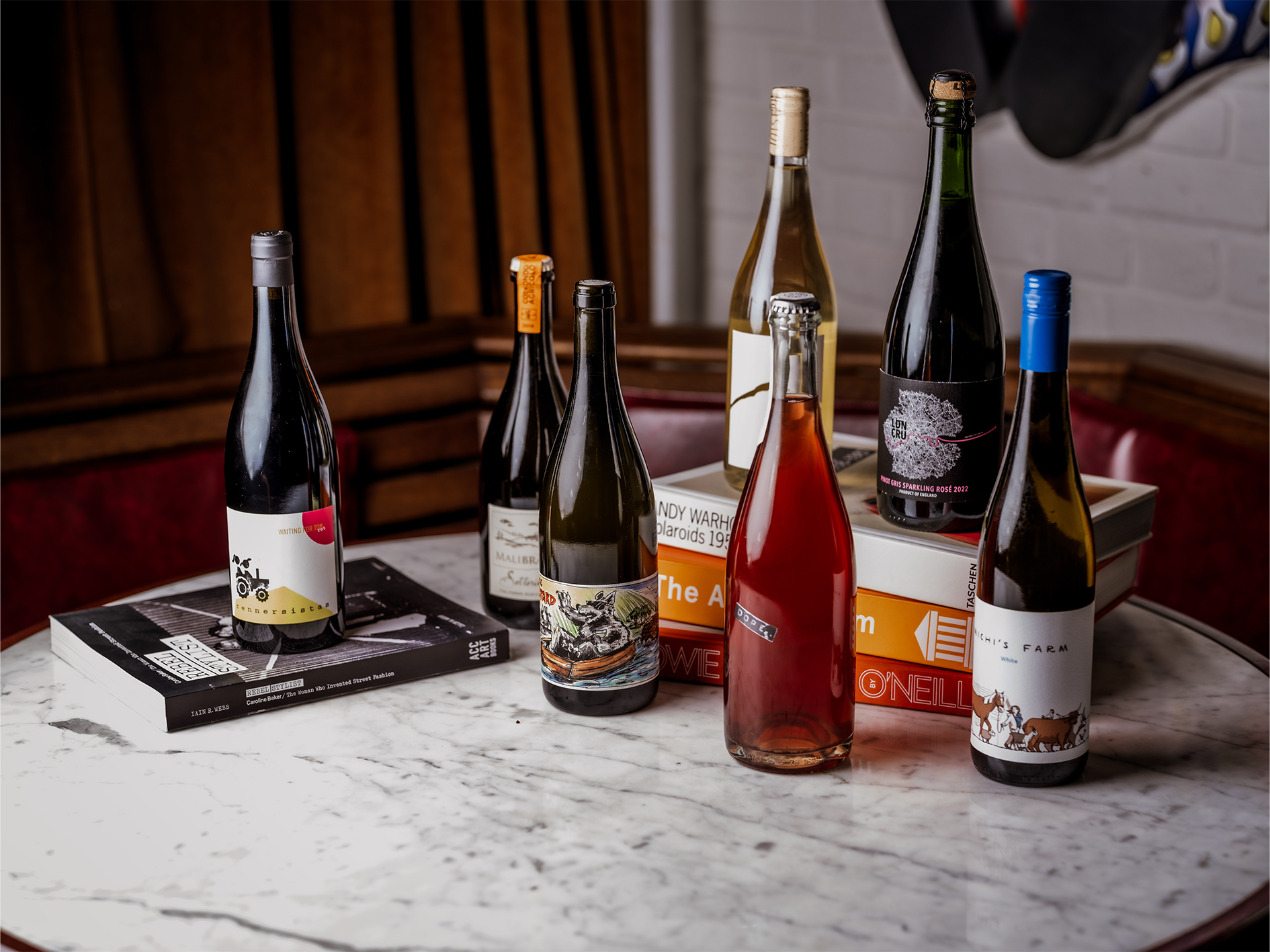 Curated wine selection on marble table at Cafe KOKO for events and networking.