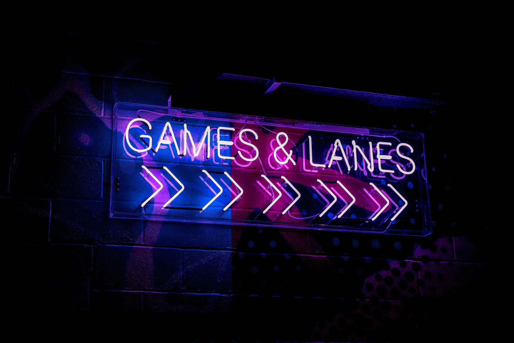 Full Venue Hire at Star Pins with vibrant "GAMES & LANES" neon sign for events.