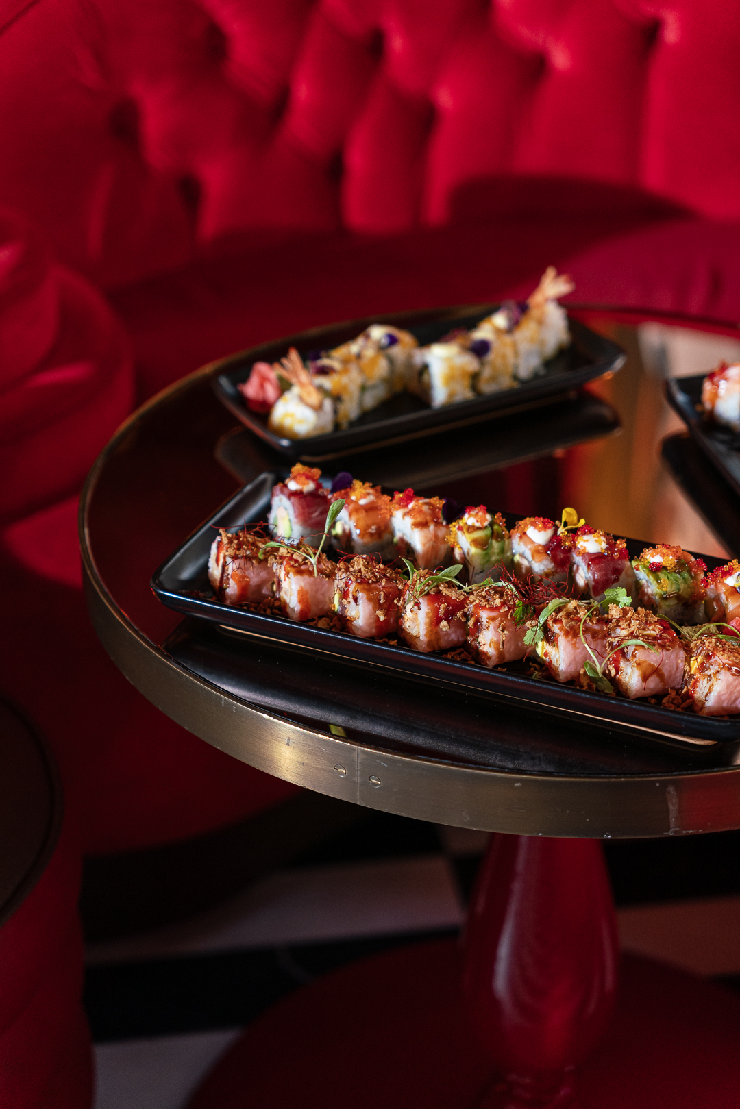 Elegant sushi rolls on a black platter, perfect for upscale events and receptions.
