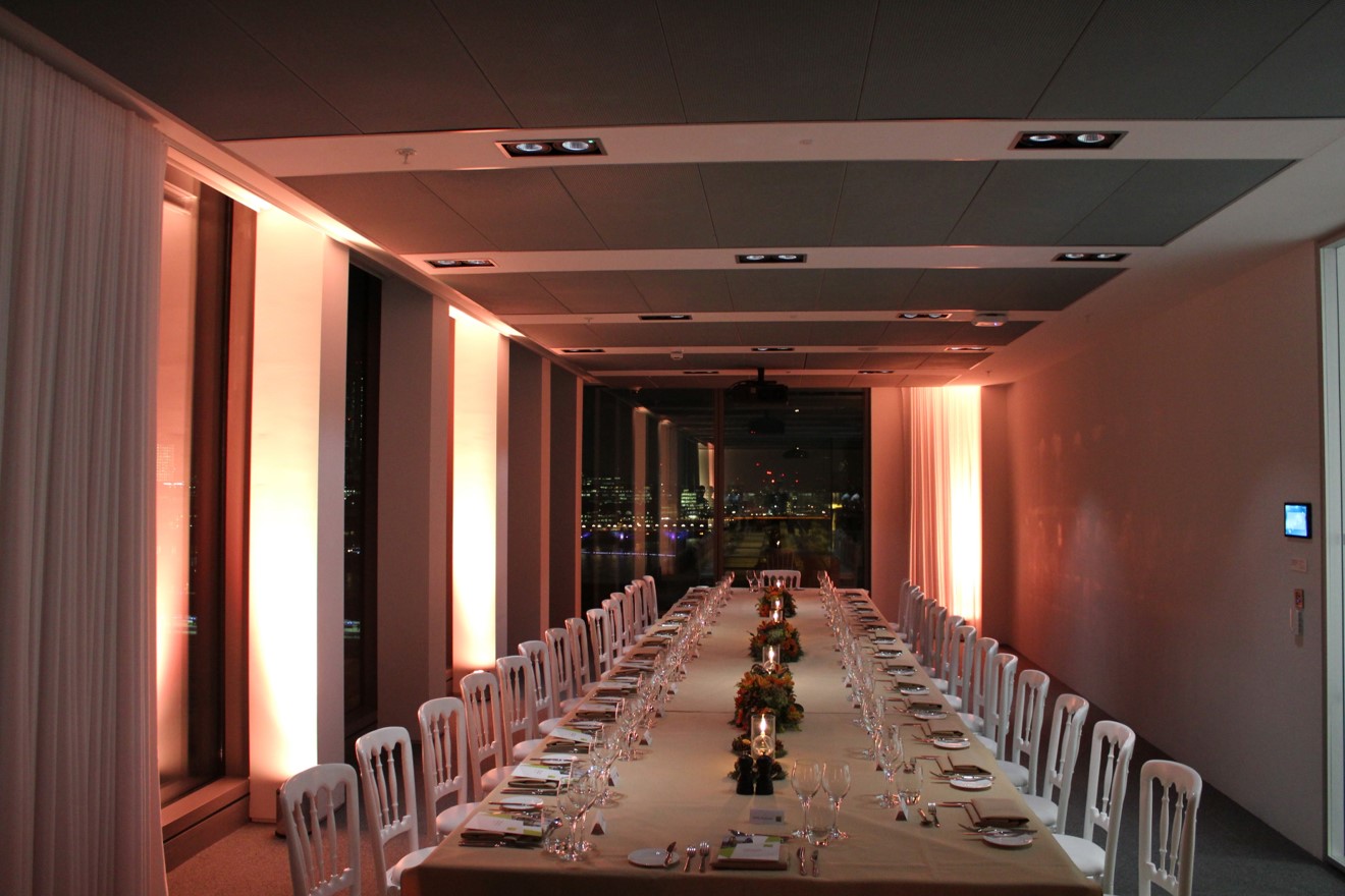 Elegant dinner setup at Sea Containers Events with city skyline view, perfect for networking.
