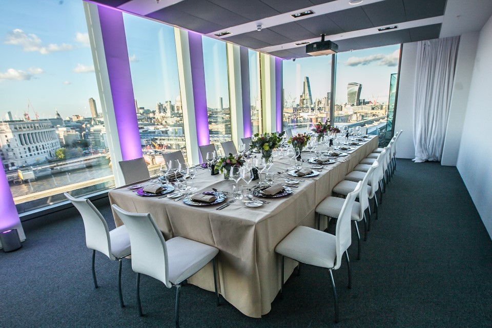 Elegant formal dinner setup at Sea Containers Events with city views, perfect for corporate gatherings.