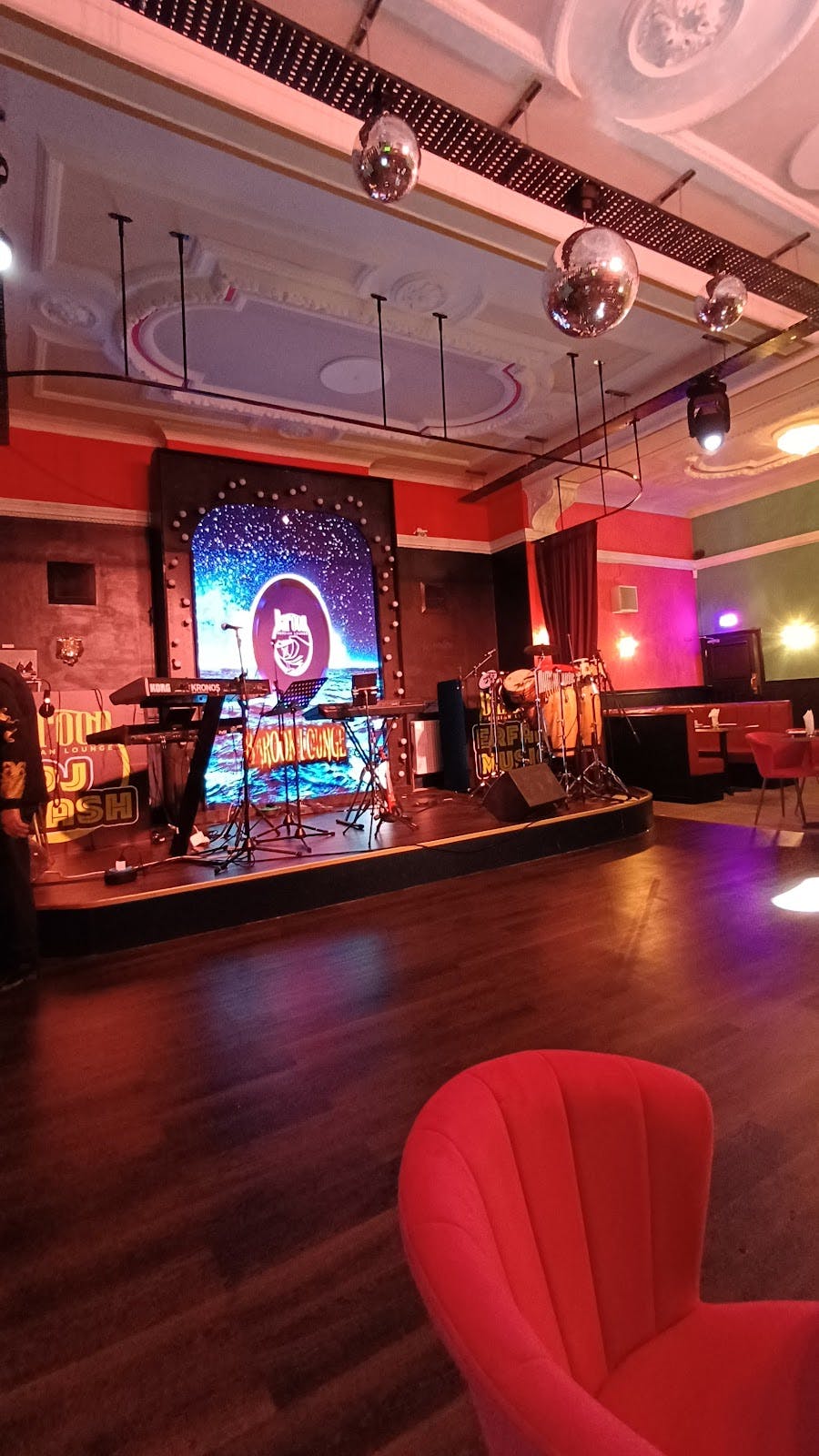 Baroon Lounge stage with LED backdrop, perfect for corporate mixers and private evening receptions.