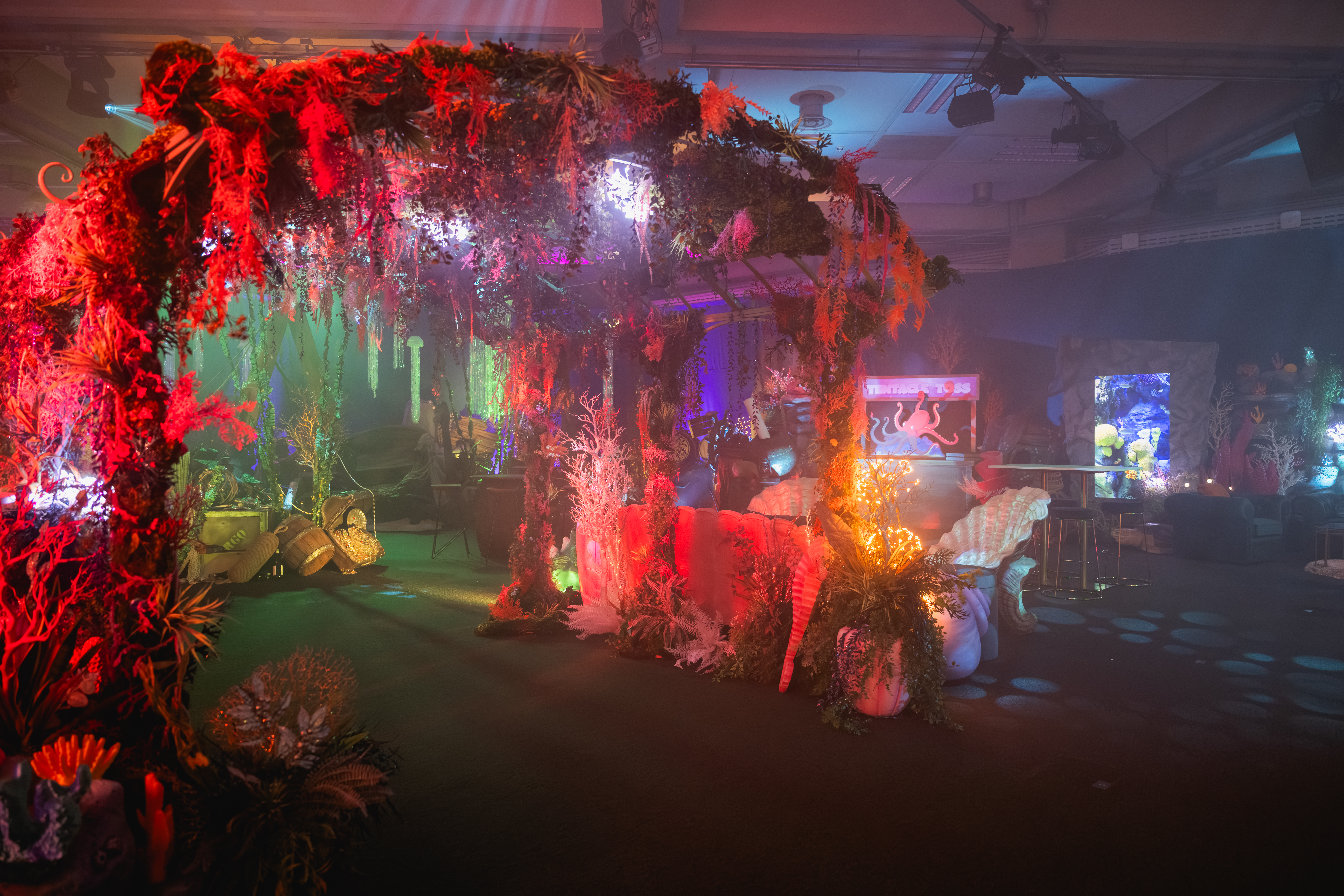 Vibrant tropical-themed event space at QEII Centre for immersive parties and gatherings.