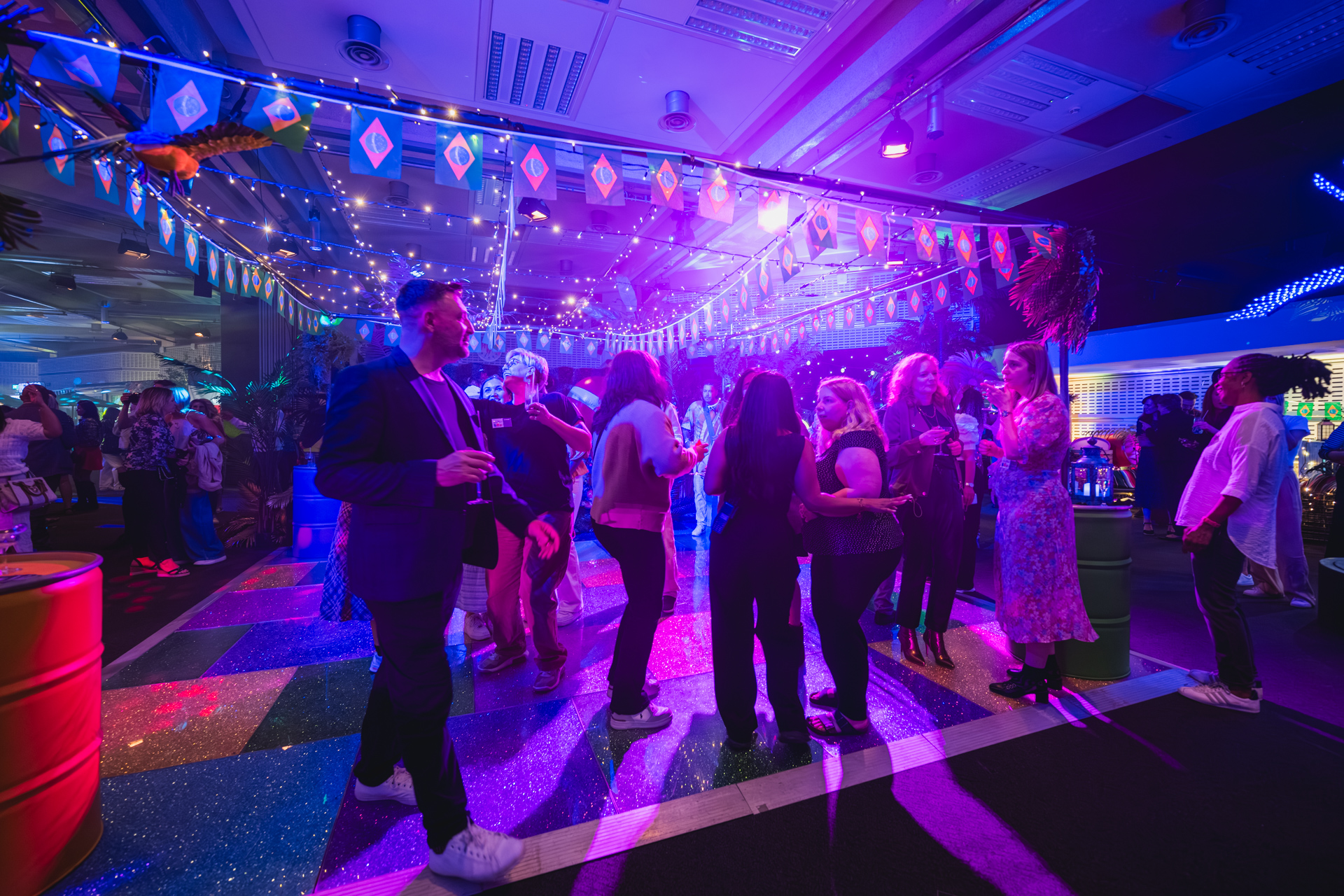 Vibrant event space at QEII Centre with colorful lighting for networking and entertainment.