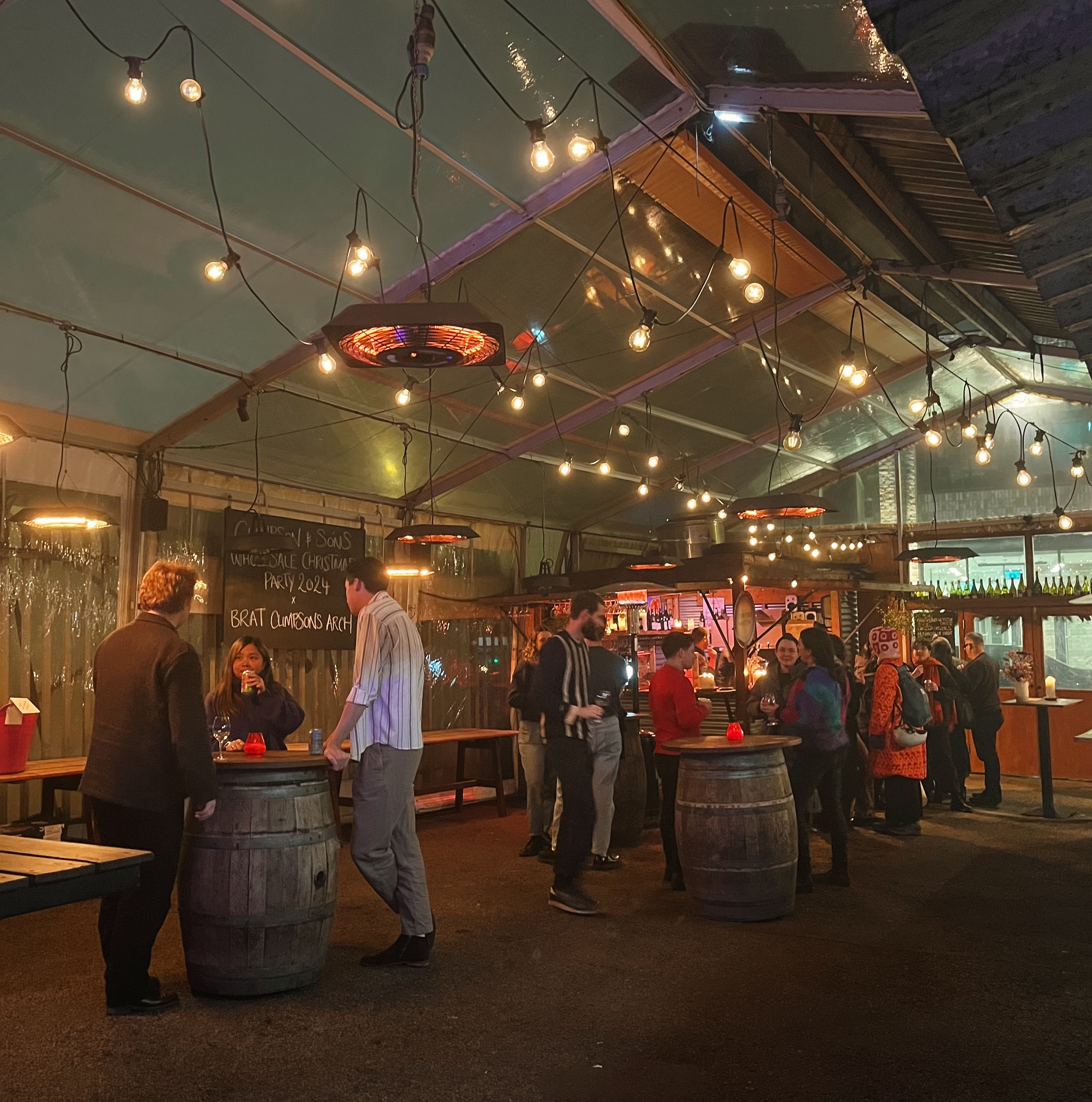 Vibrant Private Hire event in cozy tented space with warm lighting, perfect for networking.