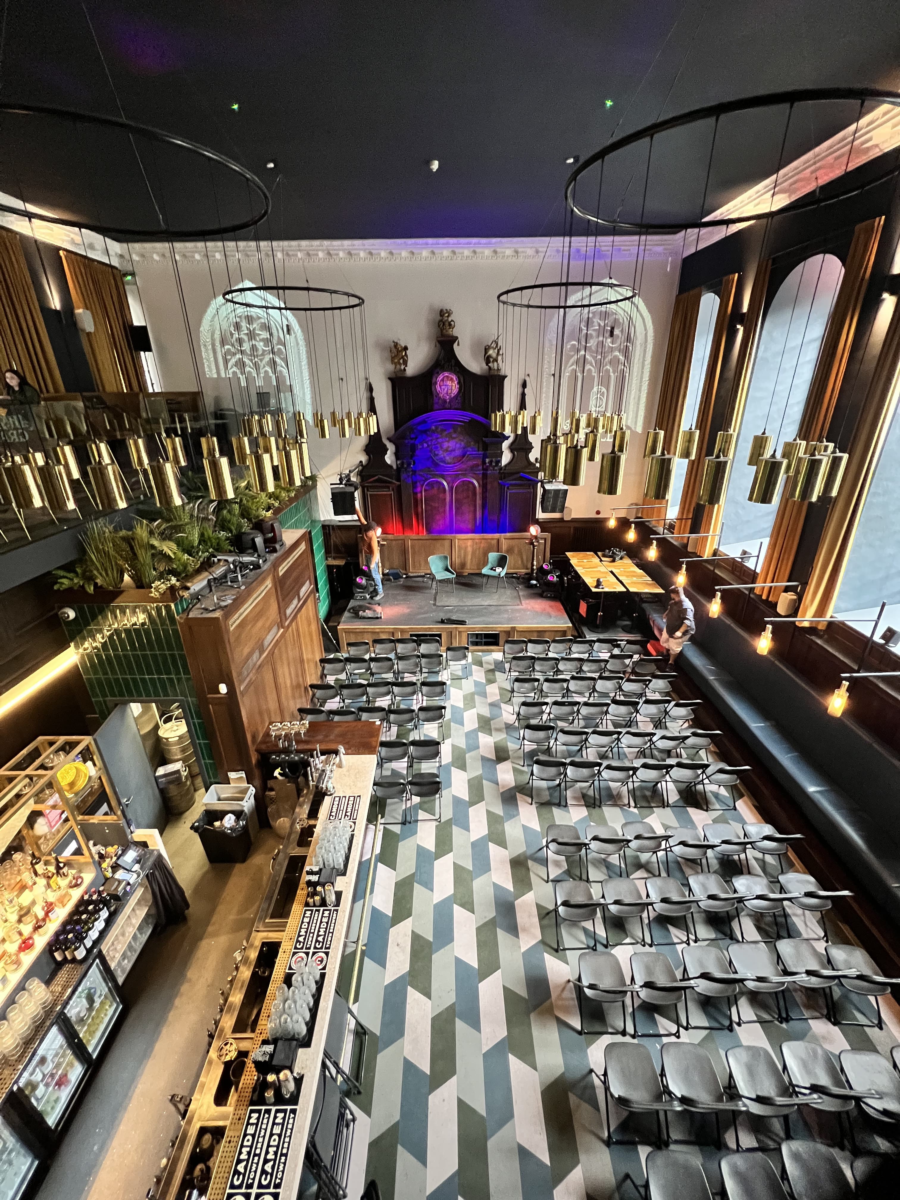 Stylish event space with elevated stage, perfect for conferences and social gatherings.