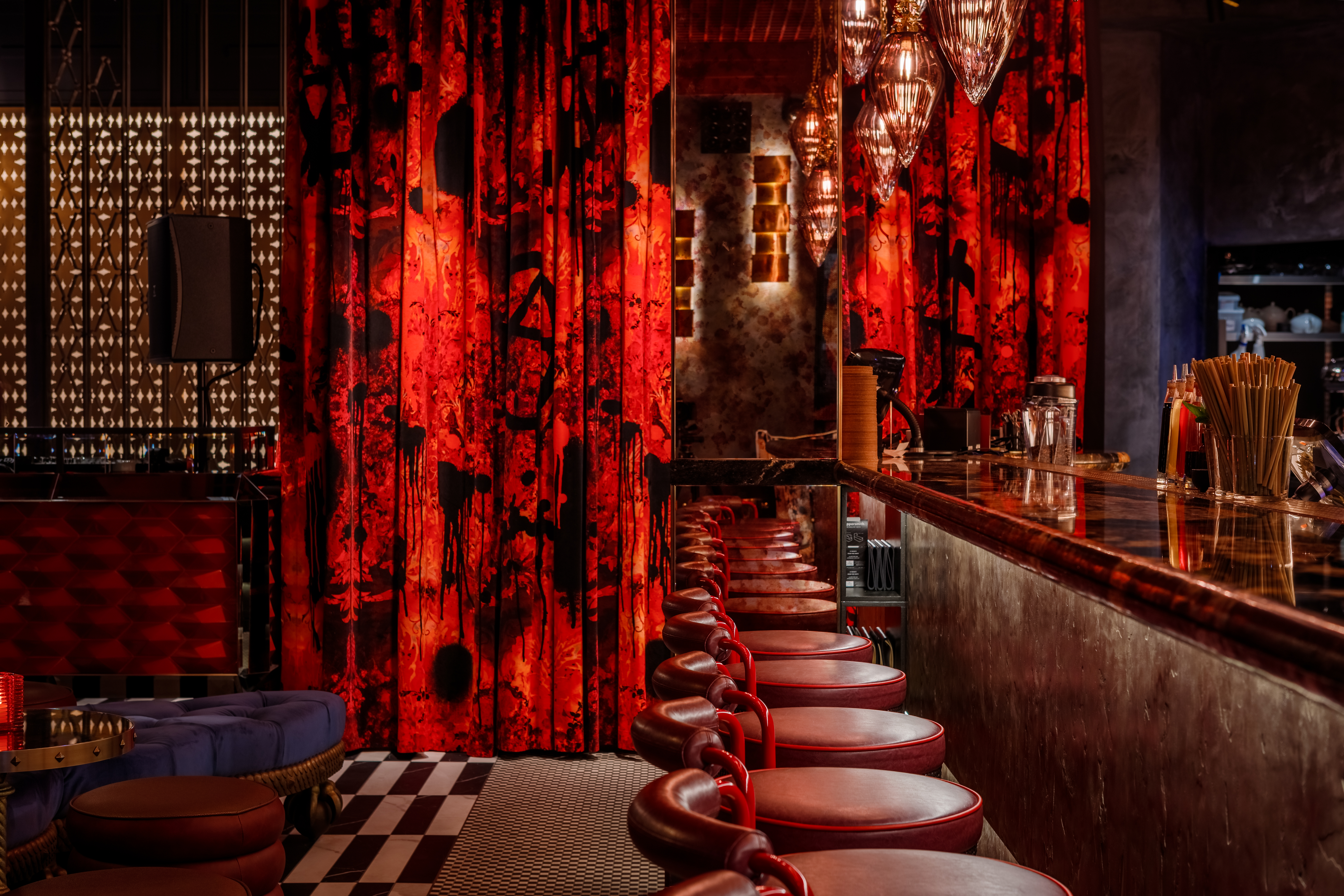 Vibrant bar at Chateau Denmark, featuring rich red decor for elegant networking events.