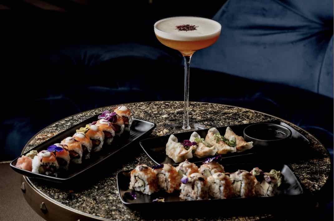Sushi platter and elegant cocktail at Thirteen, perfect for networking events.